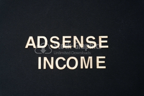 ADSENSE INCOME word written on dark paper background. ADSENSE INCOME text for your concepts