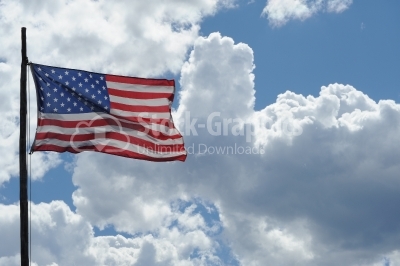 American flag on the blue sky  and clouds