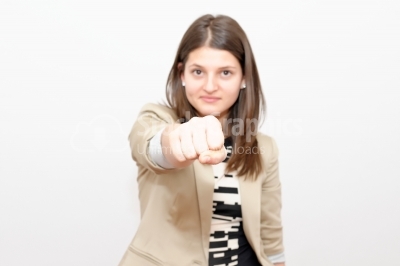 Angry young woman shows fist, Studio Shot