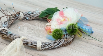 Artificial wreath on wood background