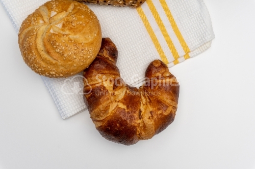Assorted breads on white towel