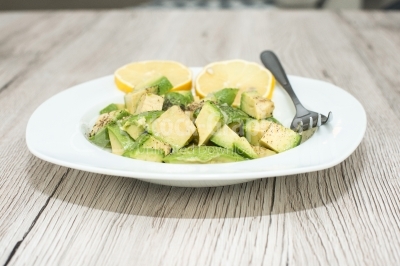 Avocado salad with lemon on white dish