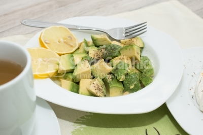 Avocado salad with lemon, pepper and salt