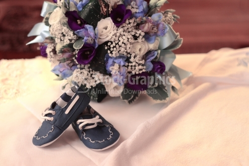Baby shoes and floral arrangement