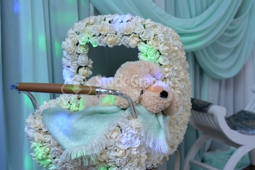 Baby stroller with flowers and teddy bear