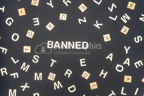 BANNED word written on dark paper background. BANNED text for your concepts