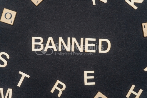 BANNED word written on dark paper background. BANNED text for your concepts