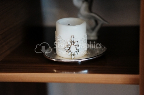 Baptismal delicate white candle wrapped with a ribbon cameo