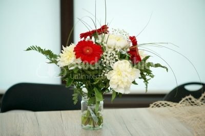 Beautiful bright gerbera in glass vase on wooden background