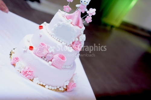 Beautiful pink birthday cake with little figurine on top