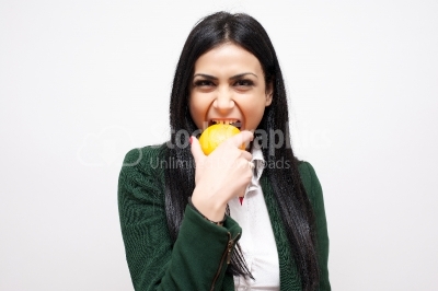 Beautiful woman eating grapefruit