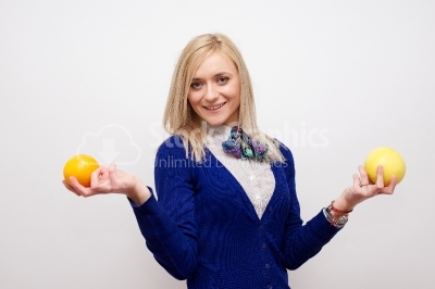 Beautiful woman holding grapefruit and orange