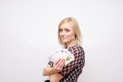 Beautiful young woman holding poker cards