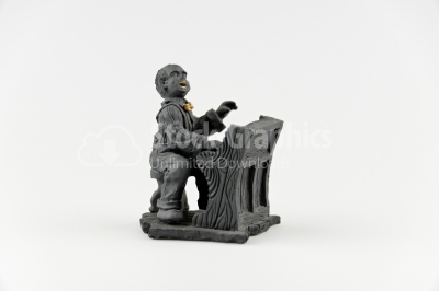Black ceramic ornament photo- man who plays the piano