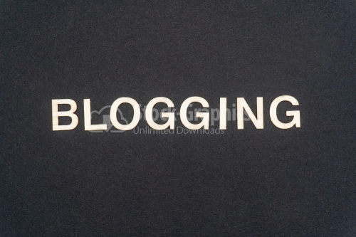 BLOGGING word written on dark paper background. BLOGGING text for your concepts