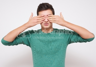 Boy covers his eyes with hands - Stock Image