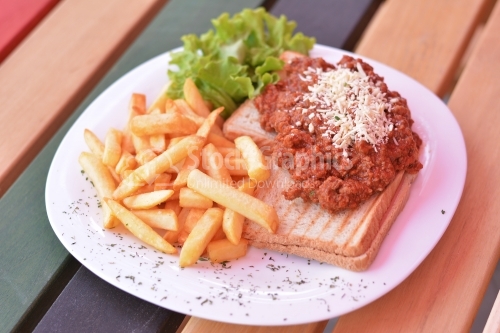 Bruschetta with minced meat and cheese, french fries and lettuce.