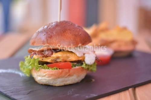 Burger menu with egg, chicken, beef, tomatoes and salad, on the black slate signboard