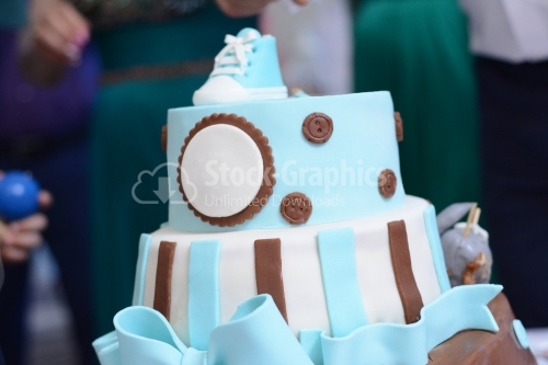 Cake covered with blue marzipan. Cake with blue boots on top