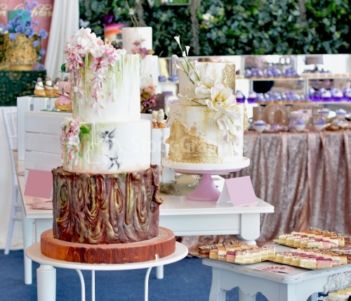 Cake exhibition. Cakes, cake with gold foil and hand painted flowers