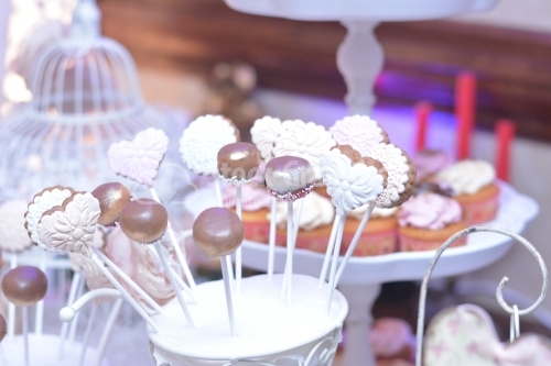 Cake pops with gold and silver powder, and white and pink fondant