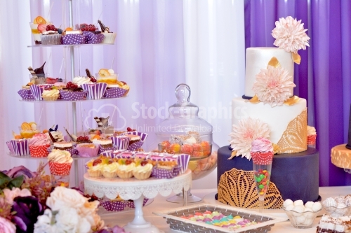 Candy bar. Table with sweets, candies, dessert. Cake with big beige chrysanthemums.