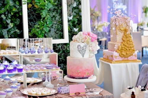 Candy bar. White-pink cake, with pink flowers, gold foil and messages of love