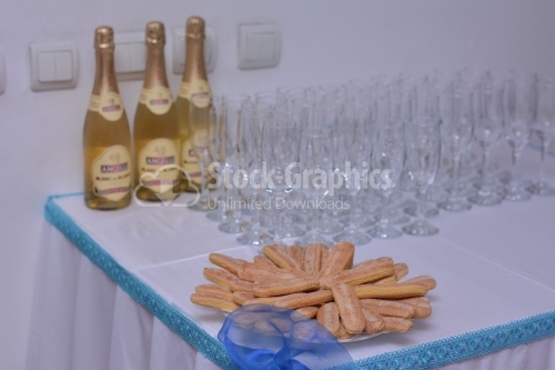 Champagne, glasses and cookie on the table