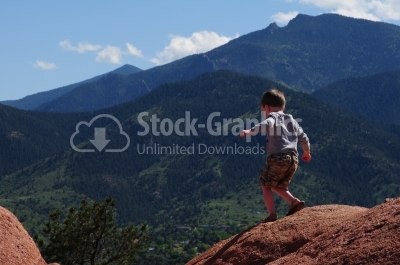 Child standing on a rock