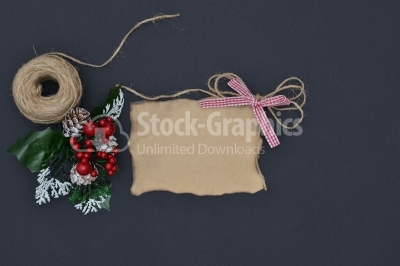 Close up of a note card with ribbon bow and christmas decoration