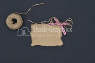 Close up of a note card with ribbon bow on black background