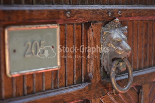 Close up of antique metal iron door knocker in shape of lion