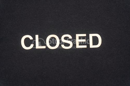 CLOSED word written on dark paper background. CLOSED text for your concepts