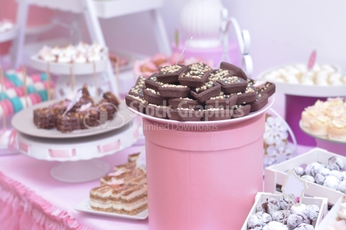 Cocoa cakes in a pink decor. Dessert table for a party.