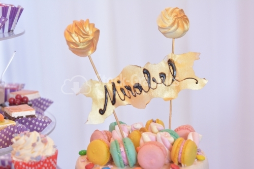 Colorful macarons cake with the name "Mirabel". Top view