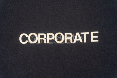 CORPORATE word written on dark paper background. CORPORATE text for your concepts