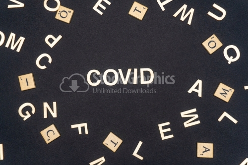 COVID word written on dark paper background. COVID text for your concepts