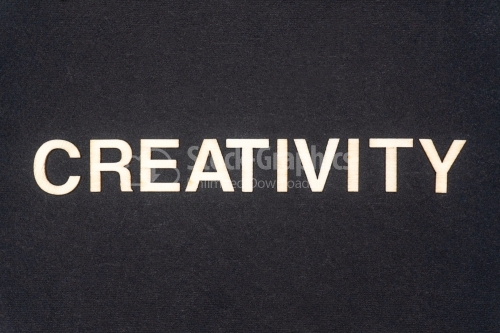 CREATIVITY word written on dark paper background. CREATIVITY text for your concepts
