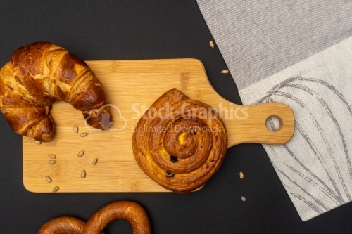 Different bread buns on wood cooking board