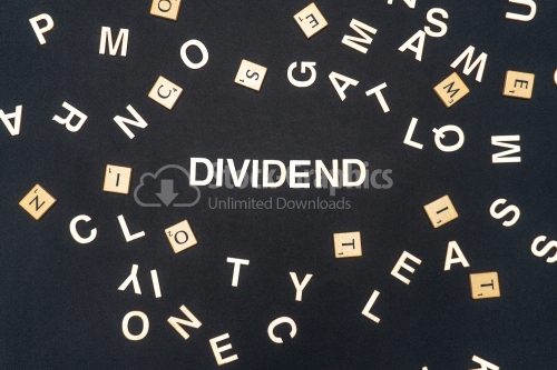 DIVIDEND word written on dark paper background. DIVIDEND text for your concepts