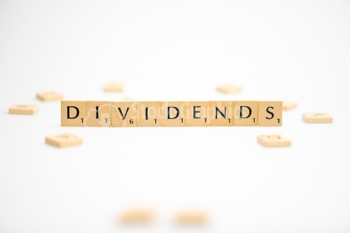 DIVIDENDS word written on white background. DIVIDENDS text on white