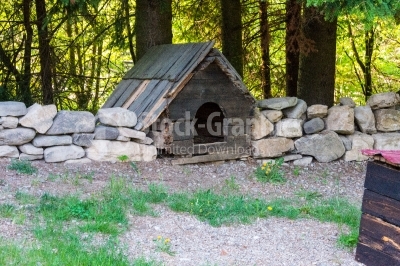 Dog house surrounded by stone fence