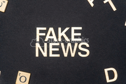 FAKE NEWS word written on dark paper background. FAKE NEWS text for your concepts
