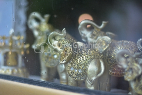 Feng shui elephants in a showcase.