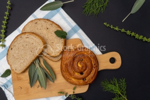 Flat lay composition with freshly baked bread on dark background