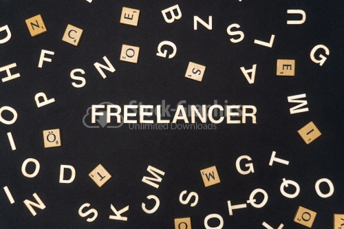 FREELANCER word written on dark paper background. FREELANCER text for your concepts