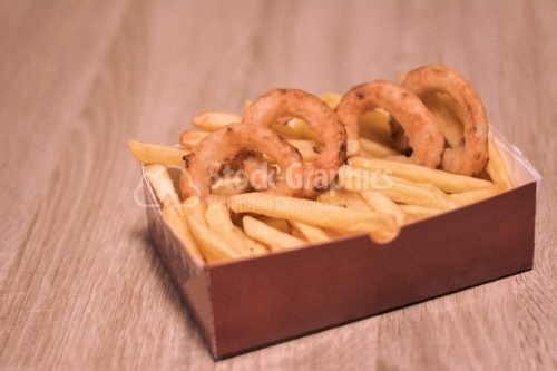 French fries and onion rounds in a cardboard box