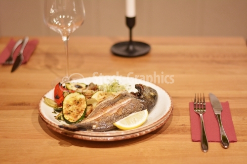 Fried trout with sauteed mushrooms and grilled vegetables.