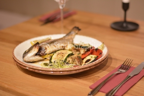 Fried trout with vegetables and wheat germ.