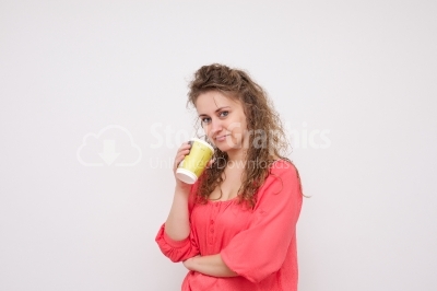 Girl enjoys her cup of tea on white background